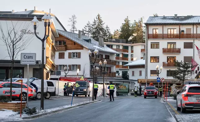 Police officers inspect the area where a fire broke out at the Le Constellation bar and lounge leaving people dead and injured, during New Year’s celebration, in Crans-Montana, Swiss Alps, Switzerland, Thursday, Jan. 1, 2026. (Alessandro della Valle/Keystone via AP)
