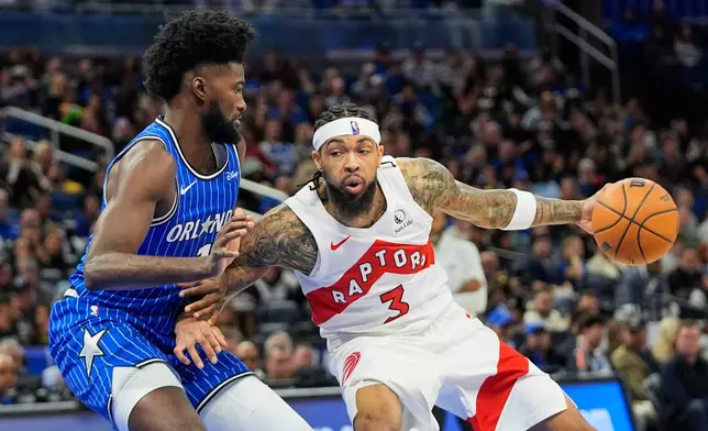Toronto Raptors forward Brandon Ingram (3) makes a move against Orlando Magic forward Jonathan Isaac, left, during the second half of an NBA basketball game, Friday, Jan. 30, 2026, in Orlando, Fla. (AP Photo/John Raoux)