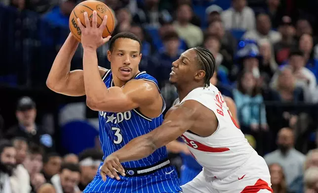 Orlando Magic guard Desmond Bane (3) tries to get past Toronto Raptors forward RJ Barrett, right, during the second half of an NBA basketball game, Friday, Jan. 30, 2026, in Orlando, Fla. (AP Photo/John Raoux)