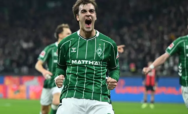 Werder Bremen's Jovan Miosevic celebrates after scoring his side's third goal during the German Bundesliga soccer match between Werder Bremen and Eintracht Frankfurt, in Bremen, Germany, Friday, Jan. 16, 2026. (dpa via AP)