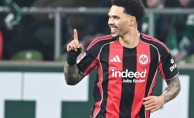Eintracht Frankfurt's Nnamdi Collins celebrates after scoring his side's second goal during the German Bundesliga soccer match between Werder Bremen and Eintracht Frankfurt, in Bremen, Germany, Friday, Jan. 16, 2026. (dpa via AP)