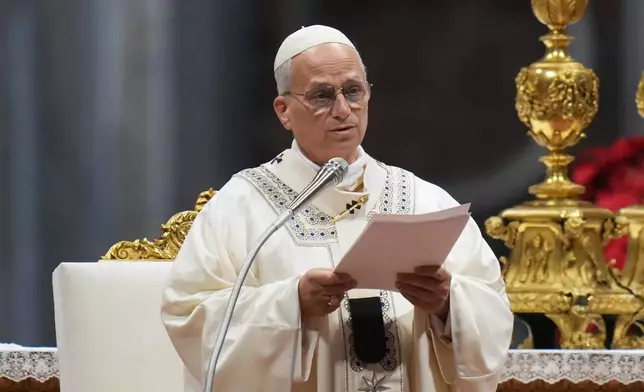 Pope Leo XIV reads the homily as he celebrates Mass on New Year's Day, in St. Peter's Basilica at the Vatican, Thursday, Jan. 1, 2026. (AP Photo/Alessandra Tarantino)