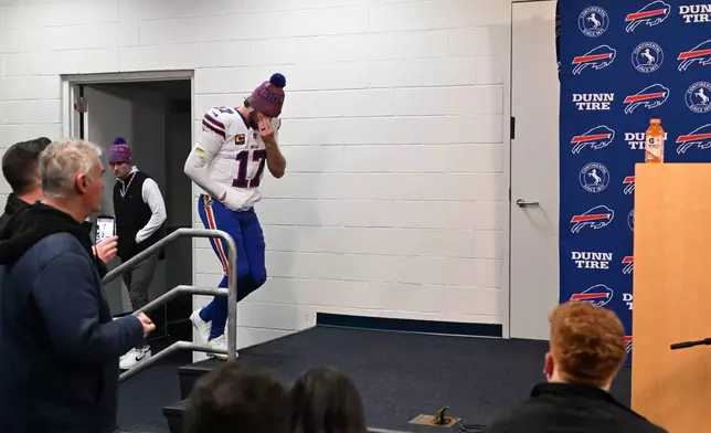 Buffalo Bills quarterback Josh Allen enters a news conference after an NFL divisional playoff game against the Denver Broncos, Saturday, Jan. 17, 2026, in Denver. (AP Photo/RJ Sangosti)