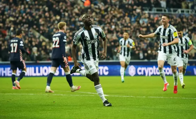 Newcastle's Yoane Wissa, center, celebrates after scoring his side's opening goal during the Champions League soccer match between Newcastle and Paris Saint-Germain in Newcastle, England, Wednesday, Jan. 21, 2026. (AP Photo/Ian Hodgson)
