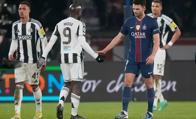 PSG's Goncalo Ramos, right, congratulates Newcastle's Yoane Wissa at the end of a Champions League opening phase soccer match between Paris Saint-Germain and Newcastle in Wednesday, Jan. 28, 2026. (AP Photo/Michel Euler)