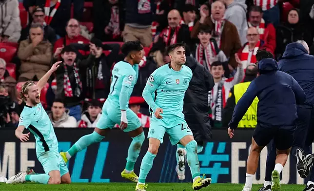 Sporting's Ivan Fresneda, front, celebrates after Alisson Santos scoring the third goal during the Champions League opening phase soccer match between Athletic Bilbao and Sporting CP, in Bilbao, Spain, Wednesday, Jan. 28, 2026. (AP Photo/Miguel Oses)