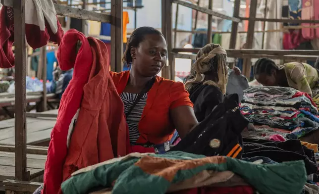Justine Bunyere, mother of nine children, sells her goods at the Kituku market on the shores of Lake Kivu in Goma, Democratic Republic of the Congo, Monday, Jan. 26, 2026, a year after M23 took control of the city. (AP Photo/Moses Sawasawa)