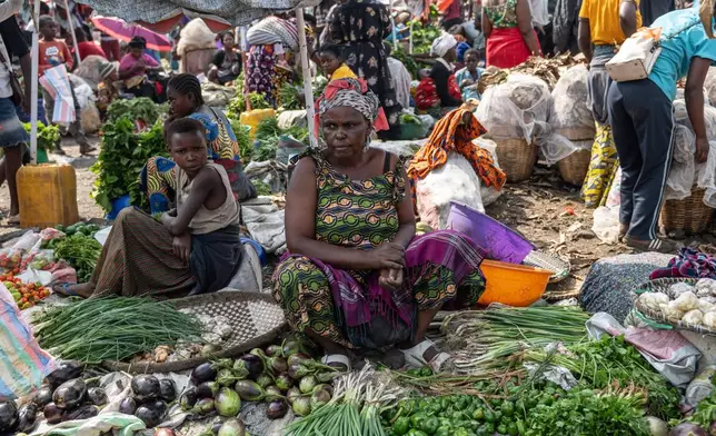 Espérance Mushashine, 44, mother of 12, sells vegetables at the Kituku market on the shores of Lake Kivu in Goma, Democratic Republic of the Congo, Monday, Jan. 26, 2026, a year after M23 took control of the city. (AP Photo/Moses Sawasawa)