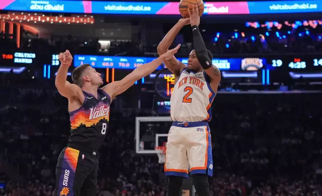 Phoenix Suns' Grayson Allen (8) defends New York Knicks' Miles McBride (2) during the first half of an NBA basketball game Saturday, Jan. 17, 2026, in New York. (AP Photo/Frank Franklin II)