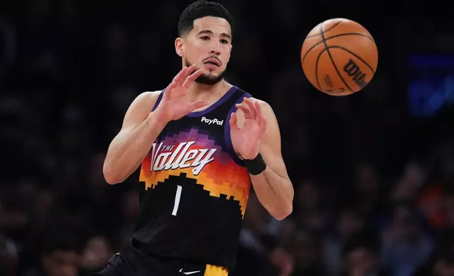 Phoenix Suns' Devin Booker (1) catches a pass during the first half of an NBA basketball game against the New York Knicks Saturday, Jan. 17, 2026, in New York. (AP Photo/Frank Franklin II)
