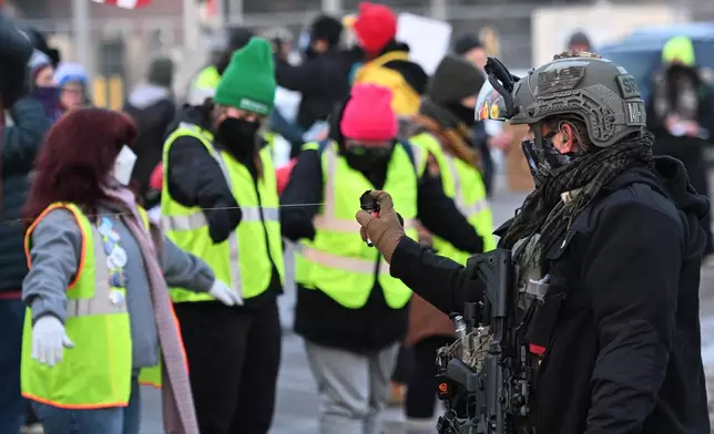 Law enforcement uses a chemical agent on protesters outside the Bishop Henry Whipple Federal Building, Thursday, Jan. 8, 2026, in Minneapolis, Minn. (AP Photo/Tom Baker)