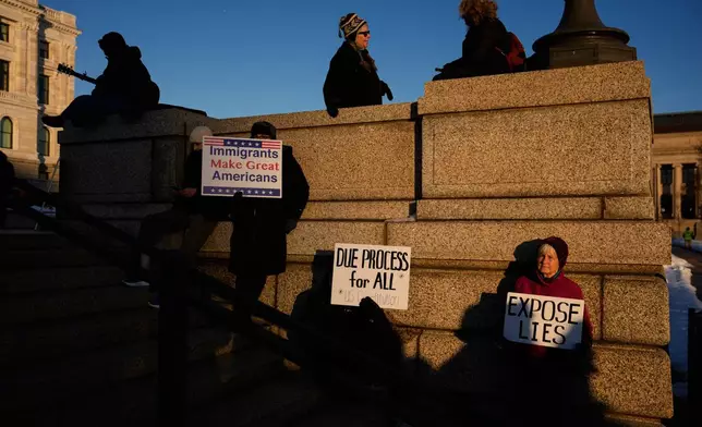 People gather for a vigil honoring Renee Good, who was fatally shot by an ICE officer in Minneapolis earlier in the week, at the Minnesota State Capitol in St. Paul, Minn., Friday, Jan. 9, 2026. (AP Photo/John Locher)