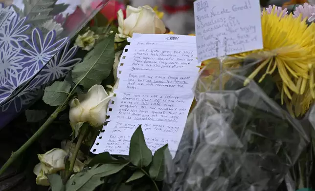 Notes and flowers are placed at a makeshift memorial honoring the victim of a fatal shooting involving federal law enforcement agents, near the site of the shooting, Thursday, Jan. 8, 2026, in Minneapolis. (AP Photo/Tom Baker)