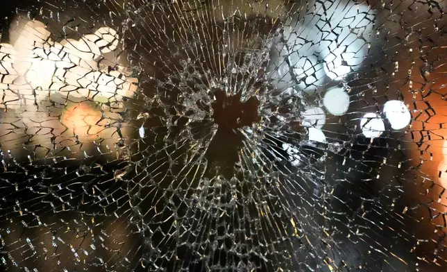 A window of the Residence Inn Minneapolis Downtown at The Depot hotel is broken after protesters broke in during a protest and noise demonstration calling for an end to federal immigration enforcement operations in the city, Friday, Jan. 9, 2026, in Minneapolis. (AP Photo/Jen Golbeck)
