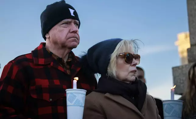 Minnesota Gov. Tim Walz and his wife, Gwen Walz, attend a vigil honoring Renee Good on Friday, Jan. 9, 2026, in St. Paul, Minn., outside the Minnesota State Capitol. (Kerem Yücel/Minnesota Public Radio via AP)