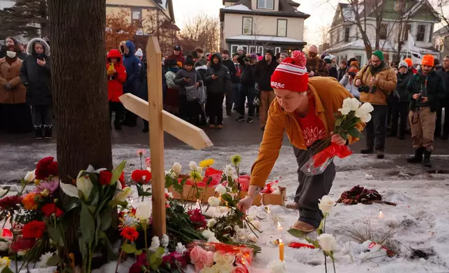 People gather for a vigil after an Immigration and Customs Enforcement officer shot and killed a motorist earlier in the day, Wednesday, Jan. 7, 2026, in Minneapolis. (AP Photo/Bruce Kluckhohn)