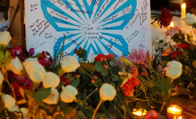 People gather for a vigil after an Immigration and Customs Enforcement officer shot and killed a motorist earlier in the day, Wednesday, Jan. 7, 2026, in Minneapolis. (AP Photo/Bruce Kluckhohn)