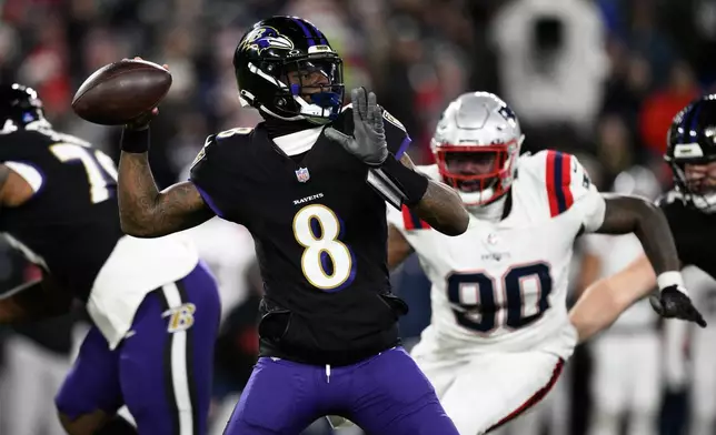 Baltimore Ravens quarterback Lamar Jackson (8) passes as New England Patriots defensive tackle Christian Barmore (90) applies pressure during the first half of an NFL football game, Sunday, Dec. 21, 2025, in Baltimore. (AP Photo/Nick Wass)