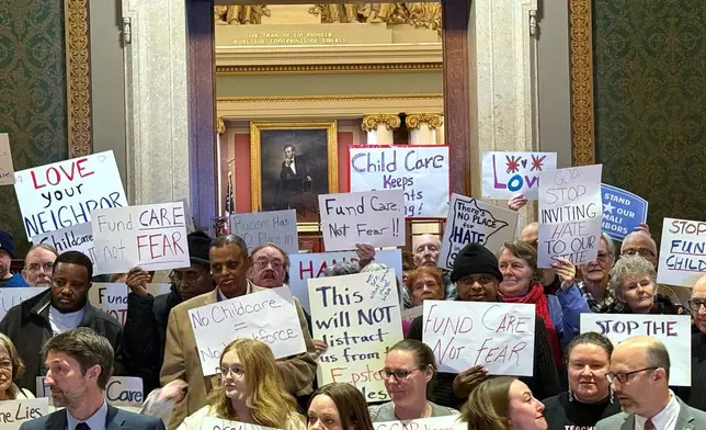 People gather for a news conference at the state capitol in St. Paul, Minn., on Wednesday, Dec. 31, 2025. (AP Giovanna Dell'Orto)
