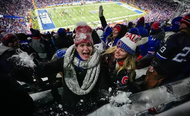 Fans celebrate and throw snow in the stands after an NFL football game between the Buffalo Bills and the New York Jets, Sunday, Jan. 4, 2026, in Orchard Park, N.Y. (AP Photo/Carolyn Kaster)