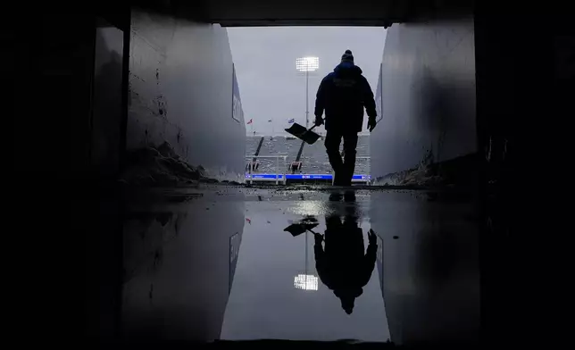 Michael Wygant shoves snow from a tunnel before an NFL football game between the Buffalo Bills and the New York Jets at Highmark Stadium, Sunday, Jan. 4, 2026, in Orchard Park, N.Y. (AP Photo/Carolyn Kaster)