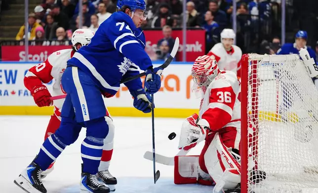 Detroit Red Wings goaltender John Gibson (36) makes a save on Toronto Maple Leafs' Bobby McMann (74) during the second period of an NHL hockey game in Toronto, Wednesday, Jan. 21, 2026. (Frank Gunn/The Canadian Press via AP)