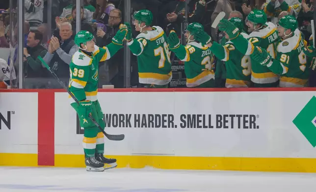 Minnesota Wild center Ben Jones (39) is congratulated after scoring during the first period of an NHL hockey game against the New York Islanders, Saturday, Jan. 10, 2026, in St. Paul, Minn. (AP Photo/Bailey Hillesheim)