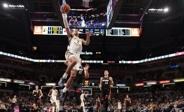 Indiana Pacers guard Andrew Nembhard (2) shoots in front of Miami Heat forward Jaime Jaquez Jr. (11) during the first half of an NBA basketball game in Indianapolis, Saturday, Jan. 10, 2026. (AP Photo/AJ Mast)