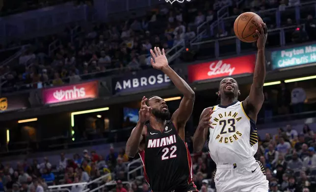 Indiana Pacers guard Aaron Nesmith (23) looks to shoot in front of Miami Heat forward Andrew Wiggins (22) during the first half of an NBA basketball game in Indianapolis, Saturday, Jan. 10, 2026. (AP Photo/AJ Mast)
