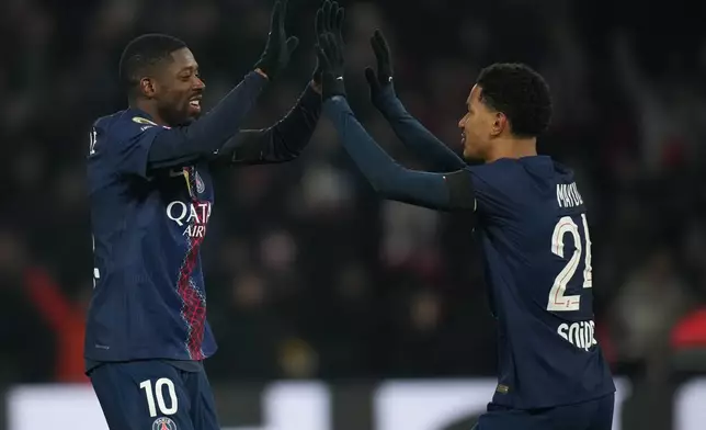 PSG's Ousmane Dembele, left, and Senny Mayulu celebrate after a goal during the French Ligue 1 soccer match between Paris Saint-Germain and Paris FC in Paris, Sunday, Jan. 4, 2026. (AP Photo/Christophe Ena)