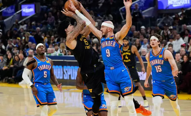 Golden State Warriors forward Gui Santos (15) is fouled by Oklahoma City Thunder guard Alex Caruso (9) during the first half of an NBA basketball game, Friday, Jan. 2, 2026, in San Francisco. (AP Photo/Godofredo A. Vásquez)