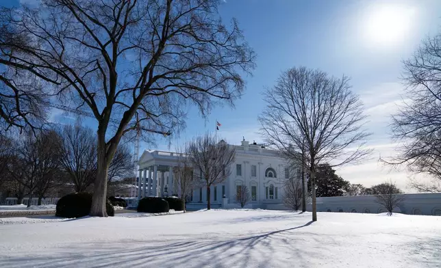 Snow covers the ground in front of the White House, Friday, Jan. 30, 2026, in Washington. (AP Photo/Allison Robbert)
