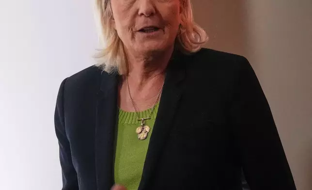 Far-right leader Marine Le Pen arrives at National Rally president Jordan Bardella's New Year address to the press, Monday, Jan. 12, 2026 in Paris. (AP Photo/Christophe Ena)