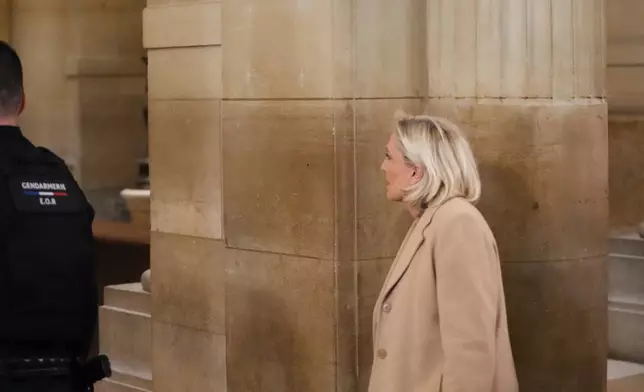 Far-right leader Marine Le Pen arrives for her appeal trial after an embezzlement conviction, Tuesday, Jan. 13, 2026 in Paris. (AP Photo/Christophe Ena)