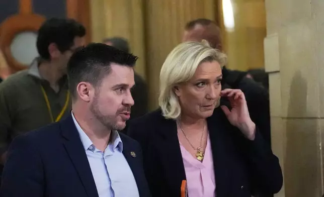 Far-right leader Marine Le Pen leaves for a break during her appeal trial after an embezzlement conviction, Tuesday, Jan. 13, 2026 in Paris. (AP Photo/Christophe Ena)