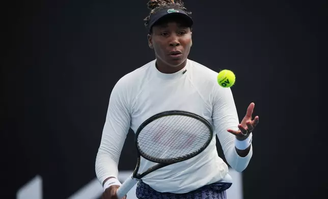 Venus Williams of the United States prepares to serve during a practice session ahead of the Australian Open tennis championship in Melbourne, Australia, Friday, Jan. 16, 2026. (AP Photo/Dita Alangkara)