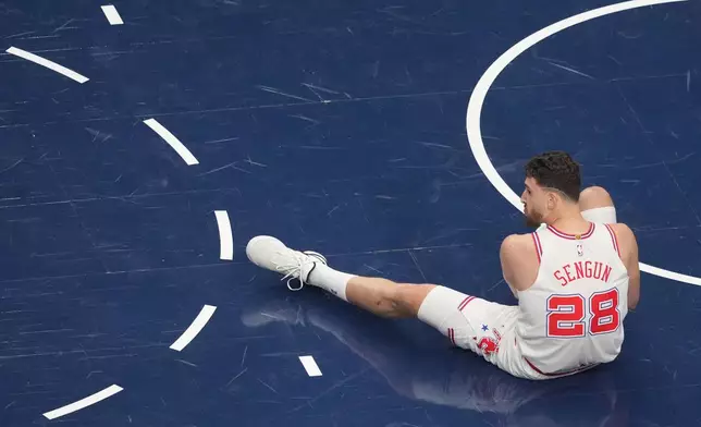 Houston Rockets center Alperen Sengun rests on the floor after falling on a play against the Dallas Mavericks during the first half of an NBA basketball game Saturday, Jan. 3, 2026, in Dallas. (AP Photo/Julio Cortez)