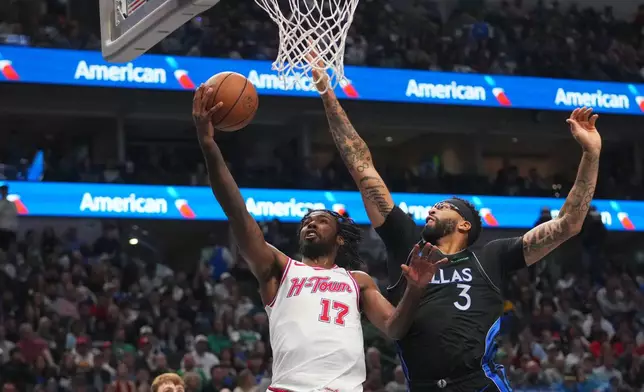 Houston Rockets forward Tari Eason (17) goes up for a basket against Dallas Mavericks forward Anthony Davis (3) during the first half of an NBA basketball game Saturday, Jan. 3, 2026, in Dallas. (AP Photo/Julio Cortez)