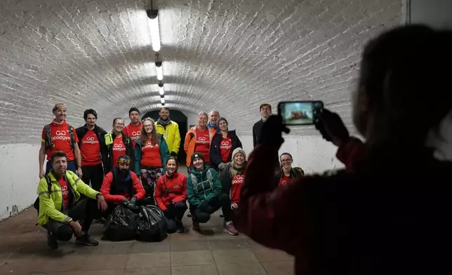 Participants in the Goodgym group pose for a group photograph after collecting litter to keep the River Thames free of plastic and other waste in London, Wednesday, Jan. 14, 2026. (AP Photo/Kirsty Wigglesworth)