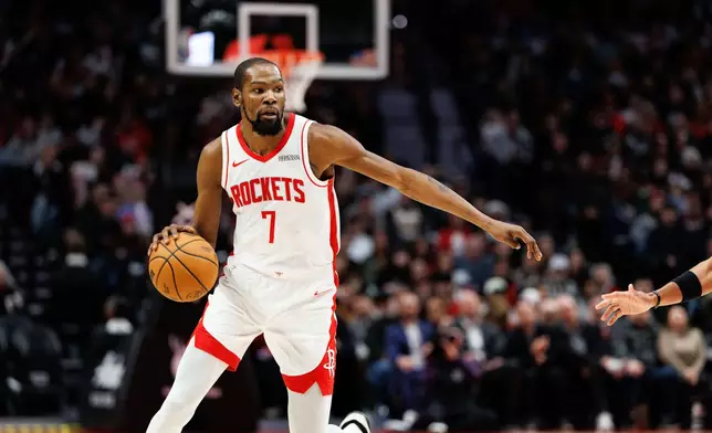 Houston Rockets forward Kevin Durant dribbles during the second half of an NBA basketball game against the Portland Trail Blazers, Friday, Jan. 9, 2026, in Portland, Ore. (AP Photo/Howard Lao)