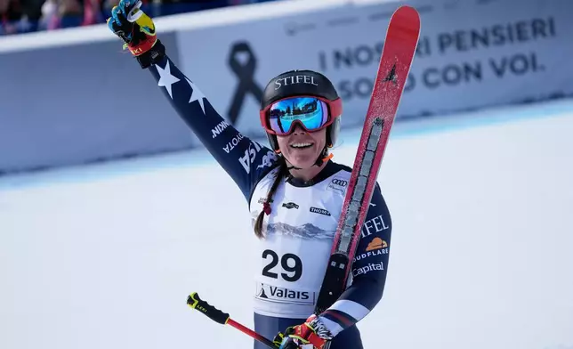 United States' Breezy Johnson celebrates at the finish area of an alpine ski, women's World Cup Super G, in Crans Montana, Switzerland, Saturday, Jan. 31, 2026. (AP Photo/Giovanni Auletta)