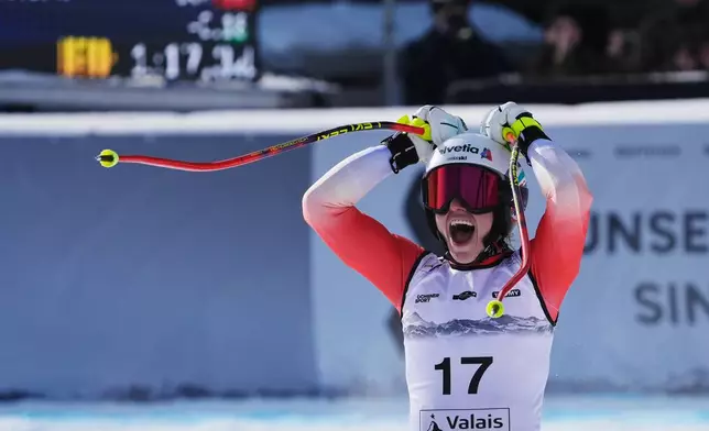 Switzerland's Malorie Blanc celebrates at the finish area of an alpine ski, women's World Cup Super G, in Crans Montana, Switzerland, Saturday, Jan. 31, 2026. (AP Photo/Giovanni Auletta)