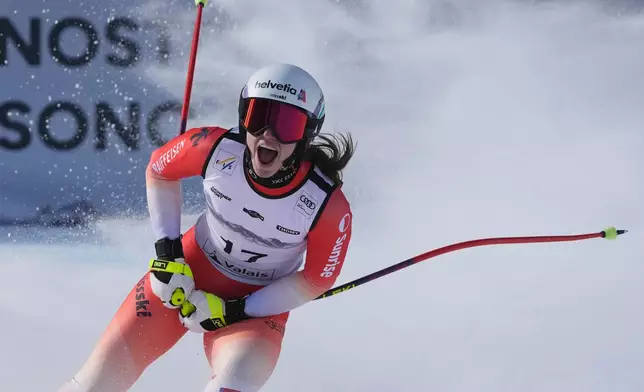 Switzerland's Malorie Blanc celebrates at the finish area of an alpine ski, women's World Cup Super G, in Crans Montana, Switzerland, Saturday, Jan. 31, 2026. (AP Photo/Giovanni Auletta)