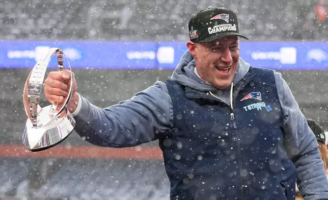 New England Patriots head coach Mike Vrabel celebrates with the trophy after the AFC Championship NFL football game between the Denver Broncos and the New England Patriots, Sunday, Jan. 25, 2026, in Denver. (AP Photo/John Locher)