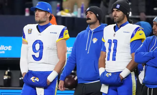Los Angeles Rams quarterback Matthew Stafford (9) quarterback Jimmy Garoppolo (11) watch from the sideline in the closing minutes of a loss to the Seattle Seahawks in the NFC Championship NFL football game Sunday, Jan. 25, 2026, in Seattle. (AP Photo/Lindsey Wasson)