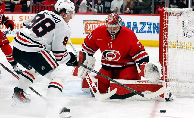 Chicago Blackhawks' Connor Bedard (98) looses control of the puck near Carolina Hurricanes goaltender Frederik Andersen during the first period of an NHL hockey game in Raleigh, N.C., Thursday, Jan. 22, 2026. (AP Photo/Karl DeBlaker)