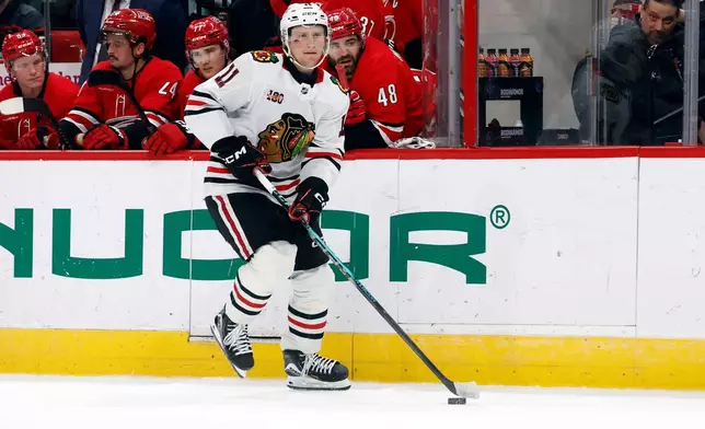 Chicago Blackhawks' Oliver Moore (11) skates with the puck during a shootout in an NHL hockey game against the Carolina Hurricanes in Raleigh, N.C., Thursday, Jan. 22, 2026. (AP Photo/Karl DeBlaker)