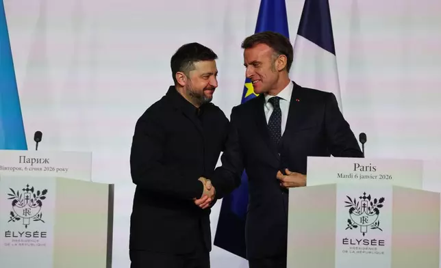 French President Emmanuel Macron, right, shakes hands to Ukraine's President Volodymyr Zelenskyy after the signing of the declaration on deploying post-ceasefire force in Ukraine during the 'Coalition of the Willing' summit on security guarantees for Ukraine, at the Elysee Palace in Paris Tuesday, Jan 6, 2026. (Ludovic Marin, Pool photo via AP)