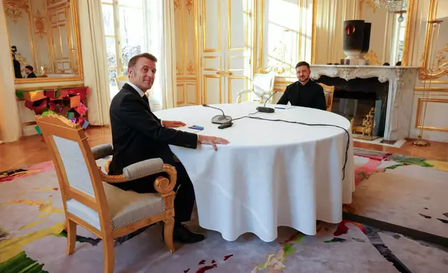 French President Emmanuel Macron, left, meets with Ukraine's President Volodymyr Zelenskyy at the Elysee Palace as part of the Coalition of the Willing meeting in Paris, France, Tuesday, Jan.6, 2026. (Yoan Valat, Pool photo via AP)