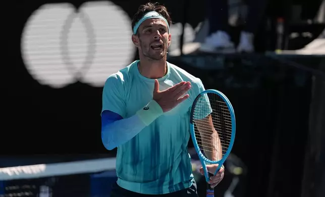 Lorenzo Musetti of Italy reacts as he plays against Taylor Fritz of the U.S. during their fourth round match at the Australian Open tennis championship in Melbourne, Australia, Monday, Jan. 26, 2026. (AP Photo/Asanka Brendon Ratnayake)